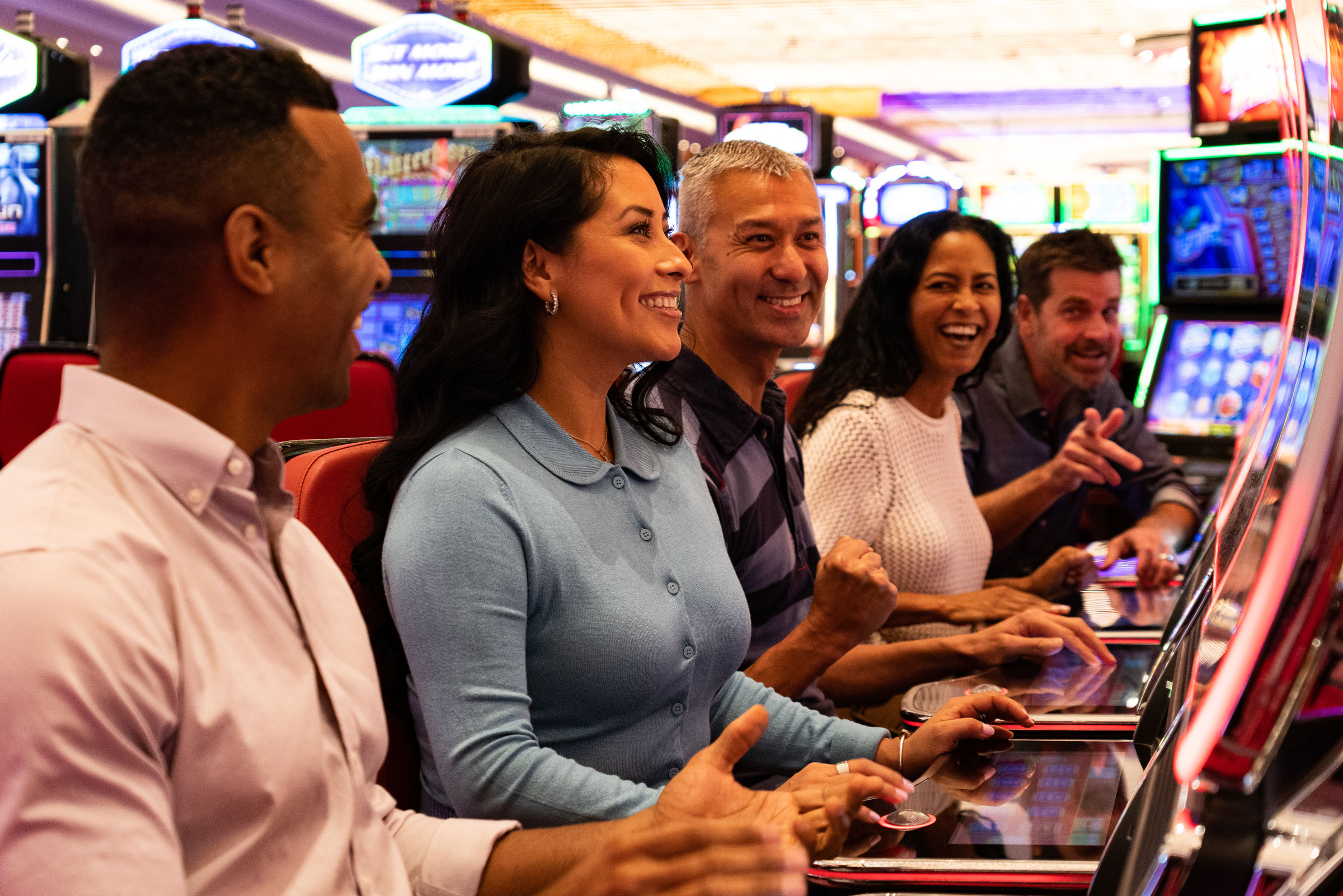 Group of guests playing slot machines